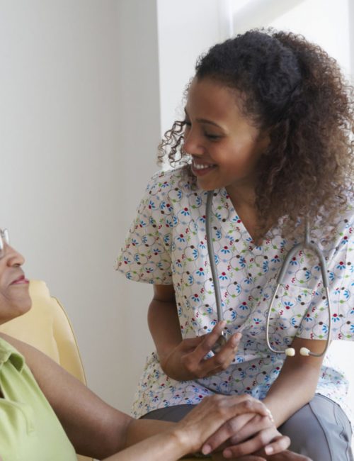 Black nurse caring for patient